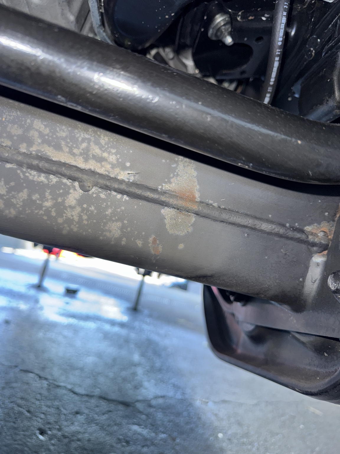 Chassis rail showing surface corrosion before treatment