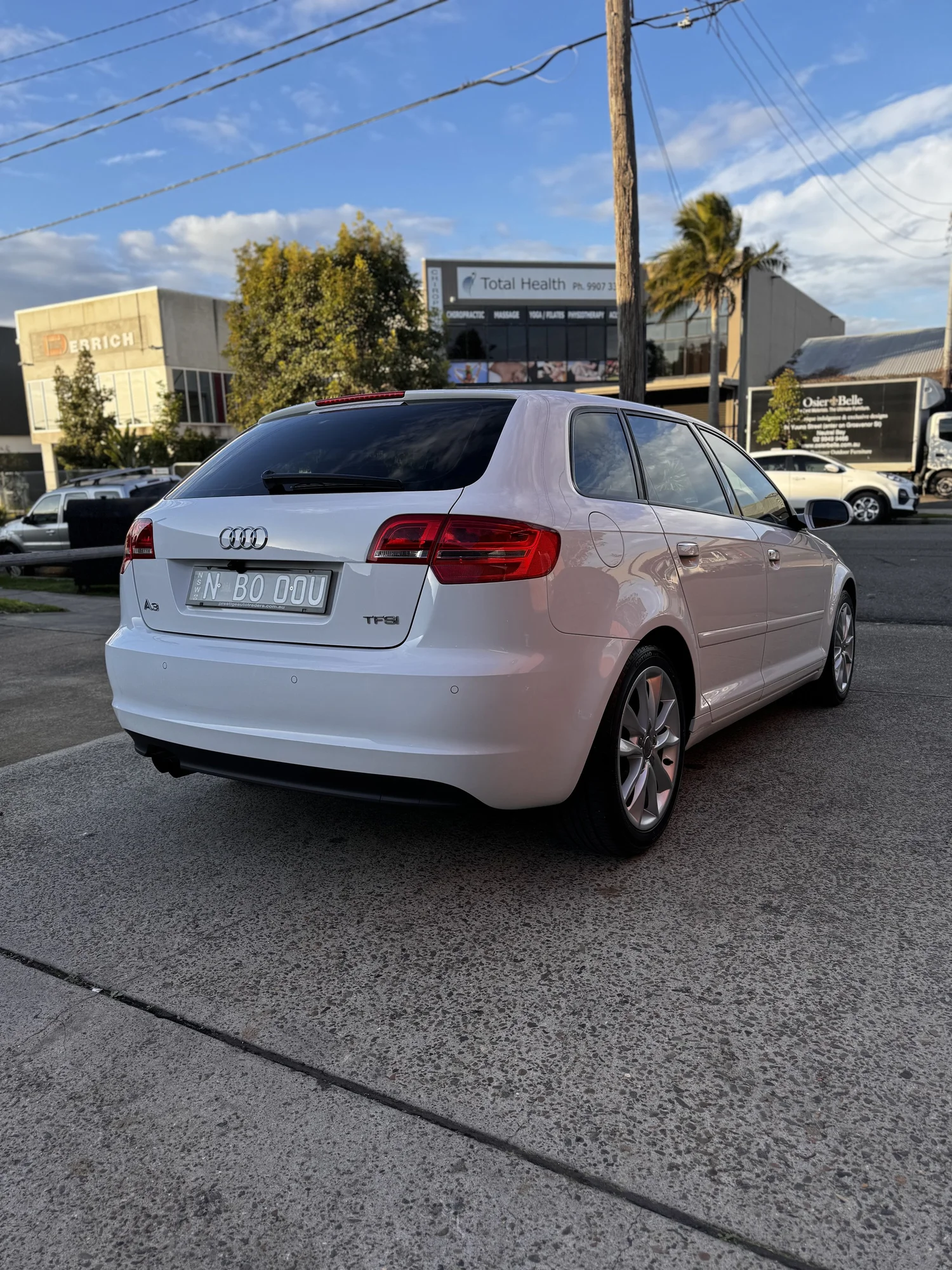 White Audi A3 complimentary loan car outside Detail AutoHaus